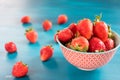 Ripe red strawberries on blue wooden table, Fresh strawberry, Strawberries in white bowl. Royalty Free Stock Photo