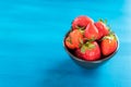 Ripe red strawberries on blue wooden table, Fresh strawberry, Strawberries in white bowl. Royalty Free Stock Photo