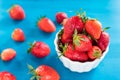 Ripe red strawberries on blue wooden table, Fresh strawberry, Strawberries in white bowl. Royalty Free Stock Photo