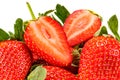 Ripe red strawberries with green leaves and two half of cutted strawberry on top isolated on white background close-up Royalty Free Stock Photo