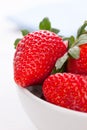 Ripe red strawberries in a white ceramic bowl on a white background Royalty Free Stock Photo