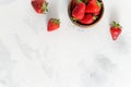 Ripe red strawberries in wooden bowl on white table. Top view, copy space. Summer fresh berries. Cookbook, sale Royalty Free Stock Photo