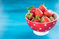 Ripe red strawberries on blue wooden table, Fresh strawberry, Strawberries in white bowl. Royalty Free Stock Photo