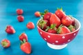 Ripe red strawberries on blue wooden table, Fresh strawberry, Strawberries in white bowl. Royalty Free Stock Photo