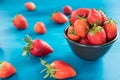 Ripe red strawberries on blue wooden table, Fresh strawberry, Strawberries in white bowl. Royalty Free Stock Photo