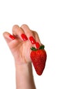 Ripe red strawberry in a beautiful female hand. Royalty Free Stock Photo