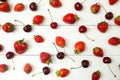 Ripe red strawberry and cherry on a white table, top view Royalty Free Stock Photo