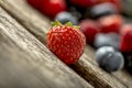 Ripe red strawberry on a rustic wooden table