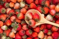 Ripe red strawberry with wooden spoon background Royalty Free Stock Photo