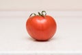 Ripe red tomato with green tassel