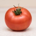 Ripe red tomato with green tassel
