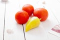 Ripe red tomatoes and bell peppers on a light wooden table Royalty Free Stock Photo