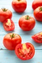 Ripe red tomatoes on a blue wooden background. Vertical foto