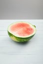 Ripe red watermelon half on wooden