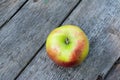 Ripe red and yellow apple on wooden table. Apple in garden. Vegetarian concept. Autumn harvest. Still life food. Royalty Free Stock Photo