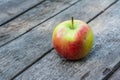 Ripe red and yellow apple on wooden table. Apple in garden. Vegetarian concept. Autumn harvest. Still life food. Royalty Free Stock Photo