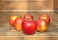 Ripe red and yellow apples on wooden floor closeup