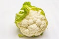 Ripe single cauliflower. Fresh whole head of cabbage, green leaves.  on white background Royalty Free Stock Photo