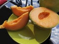 Ripe sliced cantaloupe with bright orange flesh.