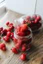 Ripe strawberries and cherries , glass jars. Wood background, rustic style. Royalty Free Stock Photo