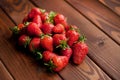 Ripe strawberries in craft paper on a wooden background. Healthy fresh food. Top view