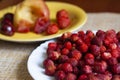 Ripe strawberries on a plate, in the background baked Apple, strawberry and cherry Royalty Free Stock Photo