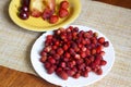 Ripe strawberries on a plate on the table, baked Apple, strawberry and cherry on a plate Royalty Free Stock Photo