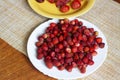 Ripe strawberries on a plate on the table, baked Apple, strawberry and cherry on a yellow plate Royalty Free Stock Photo