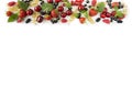 Ripe strawberries, redcurrants, blackcurrants, mulberries, raspberries and cherries on white background.