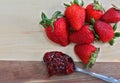 Ripe strawberries with a spoon of strawberry jam. Macro with co