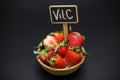 Strawberry in the basket and inscription vitamin c