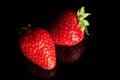 Ripe strawberry on a black background, close-up. Organic fruits