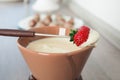 Ripe strawberry dipped into white chocolate fondu Royalty Free Stock Photo