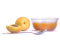 Ripe sweet apricots and glass bowl of apricot jam on white background