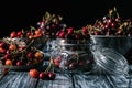 ripe sweet cherries in glass jar and colander Royalty Free Stock Photo