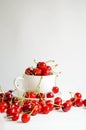 Ripe sweet cherries in a white cup on wooden background, tasty and healthy dessert Royalty Free Stock Photo