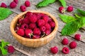 Ripe sweet and fresh raspberries in bowl with leaves Royalty Free Stock Photo