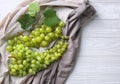 Ripe sweet grapes on white wooden table, top view