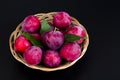 Ripe sweet plums in wicker bowl. Photo Royalty Free Stock Photo