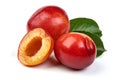 Ripe sweet red plums with leaves and a half of red plum fruit, isolated on white background. Close-up Royalty Free Stock Photo