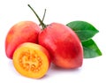 Ripe tamarillo fruits with slices and tamarillo leaves on a white background