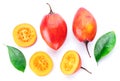 Ripe tamarillo fruits with slices and tamarillo leaves isolated on a white background Royalty Free Stock Photo