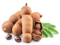 Ripe tamarind fruit, leaves and some tamarind seeds isolated on white background