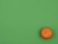 Ripe tangerine on green background. Citrus fruit. Royalty Free Stock Photo