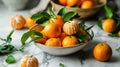 Ripe tangerines on a branch are in a plate