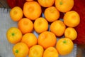 Ripe tangerines lie on the table on a red wool background. The ripening seasund and on a pink napkin. The ripening season of tropi