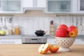 Ripe apples and blurred view of kitchen interior on background