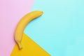 Ripe tasty banana on color background, top view space for text