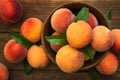 Ripe and tasty and juicy peaches lie on a plate on a wooden table. Large peaches on rustic wooden background, selective focus Royalty Free Stock Photo