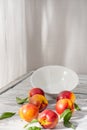 Peaches and a plate on a wooden table, nectarine Royalty Free Stock Photo